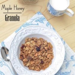A bowl of granola on a blue and white cloth.