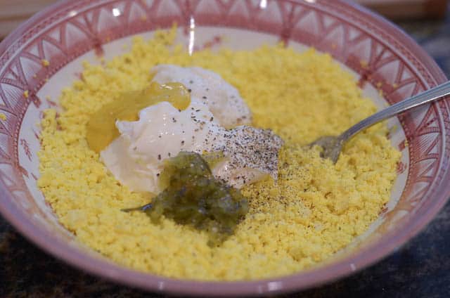 Combining the egg yolk with the other ingredients in a small bowl.