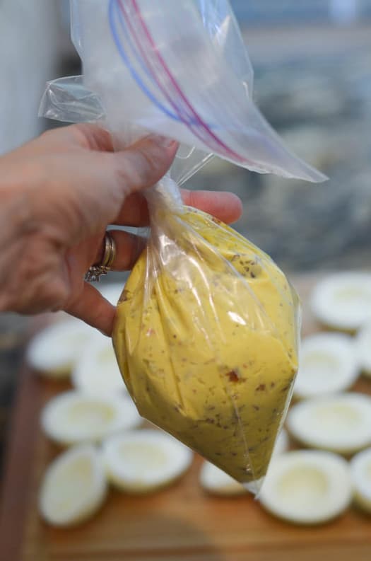The deviled egg mixture in a gallon sized plastic storage bag.
