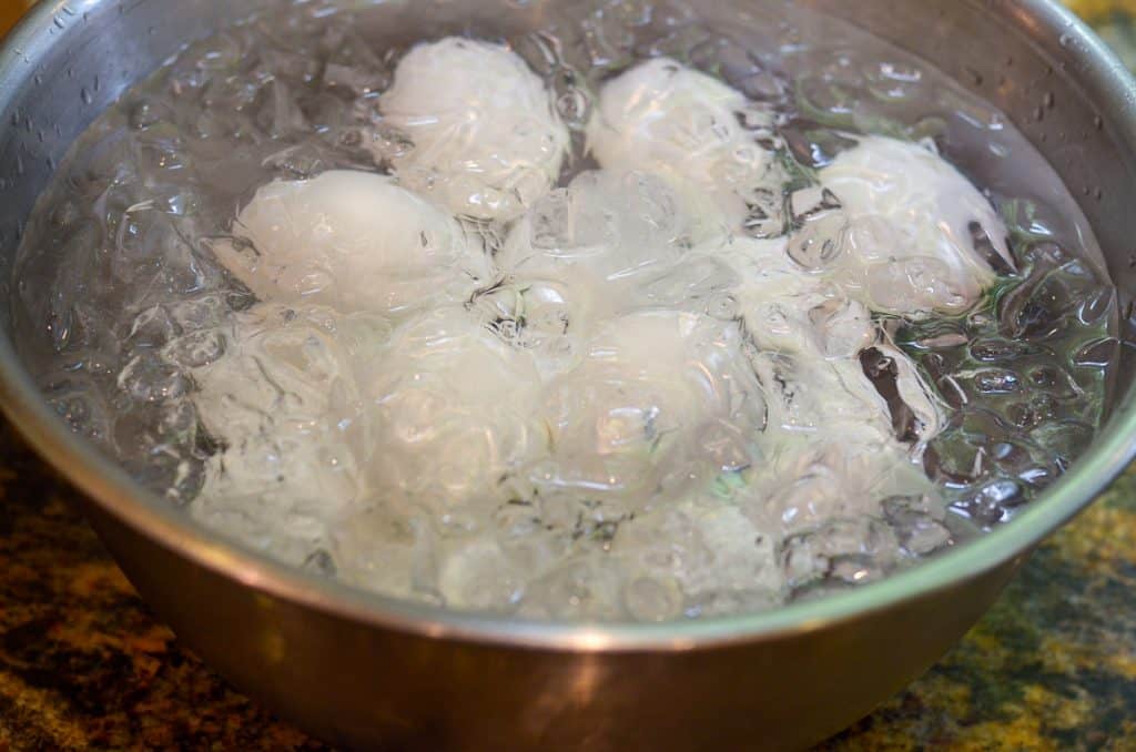 Hard boiled eggs in a bowl of ice water.