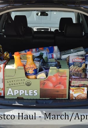A car with the trunk open and filled with groceries.