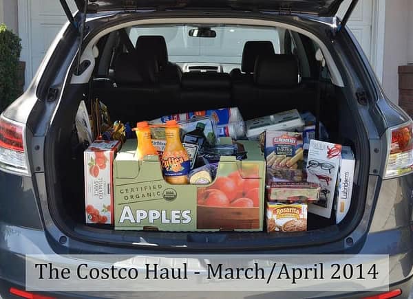A car with the trunk open and filled with groceries.