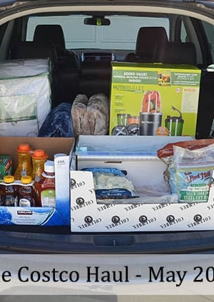A car with the trunk open and filled with groceries.