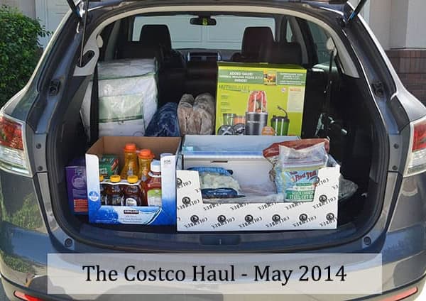 A car with the trunk open and filled with groceries.