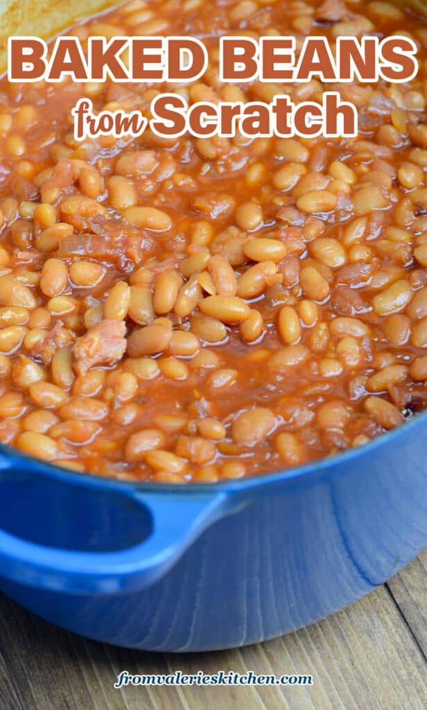 Baked beans in a blue pot on a wood board with text.