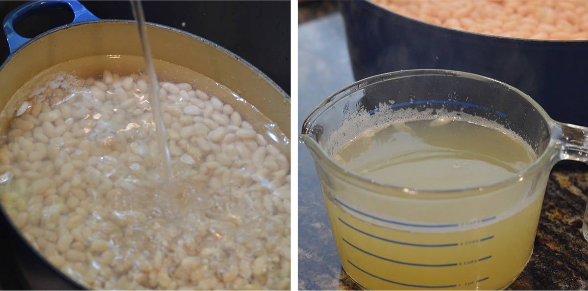 White beans in a pot covered with water and a measuring cup full of bean cooking liquid.