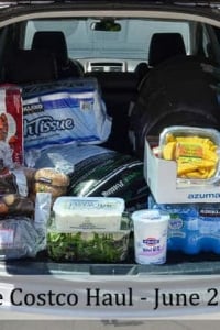 A car with the trunk open and groceries in the back.