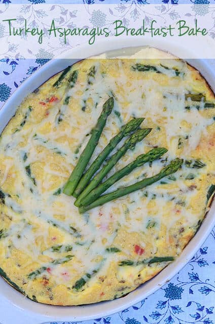 A baked egg dish topped with asparagus.