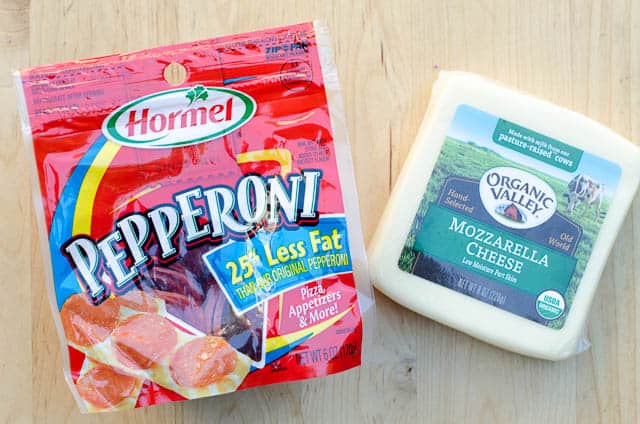 A bag of reduced fat Hormel Pepperoni and Organic Valley mozzarella cheese.