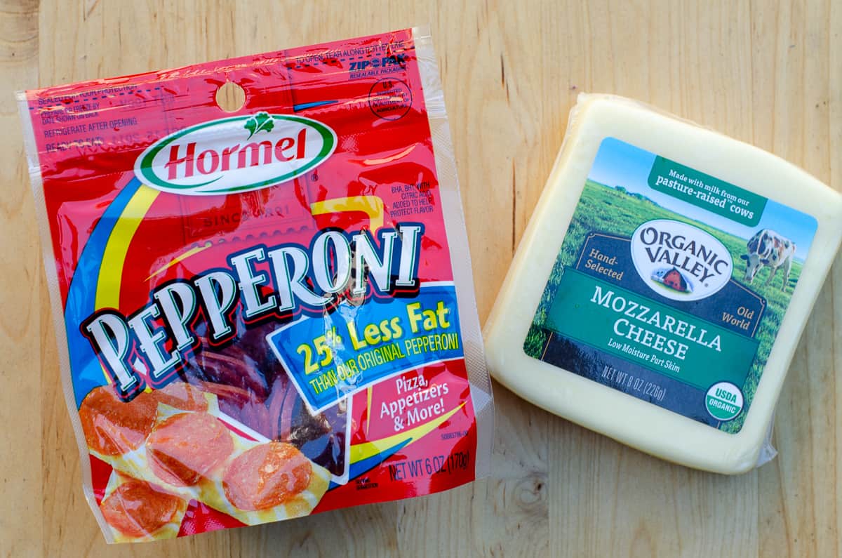 A package of Hormel pepperoni and a block of Organic Valley mozzarella cheese.