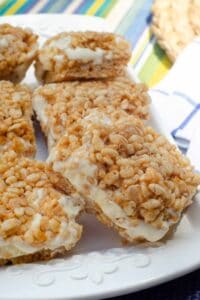 Peanut butter rice krispie ice cream sandwiches on a white platter.