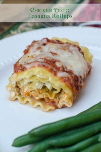 A close up of a chicken pesto lasagna rollup on a white plate.