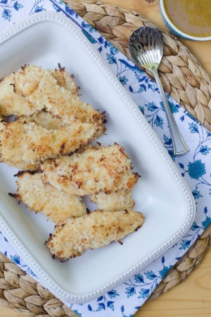 Coconut Chicken Fingers in a white dish.