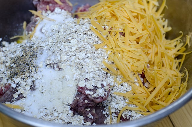 All the ingredients required to make the meatloaf mixture in a mixing bowl.