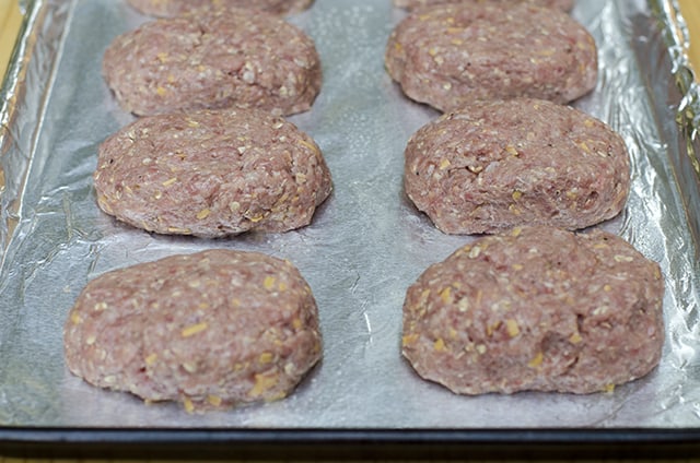 The meatloaf mixtures is formed into individual mini meatloaves and placed on a foil lined baking sheet.