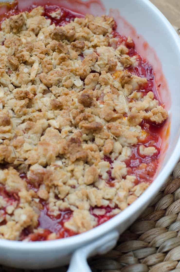 Peach Strawberry Crisp in a white baking dish.