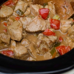 Slow Cooker Caribbean Pork just after the cooking time being stirred with a wooden spoon.