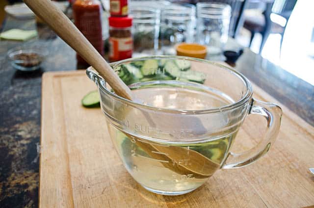 The brine is mixed in a large measuring cup.