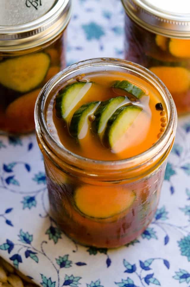 A close up image of Sriracha Refrigerator Pickles in an open mason jar.