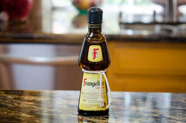 A bottle of Frangelico Liqueur on a kitchen counter.  