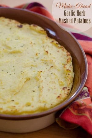 Mashed potatoes in a brown baking dish.