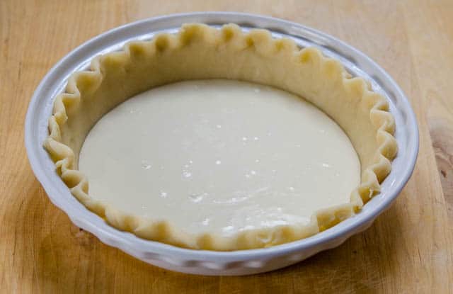 A white layer of pie filling in a pie crust.