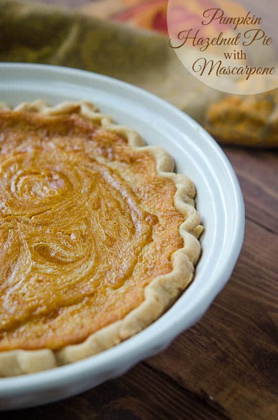 A close up of Pumpkin Hazelnut Pie with Mascarpone in a white pie dish.