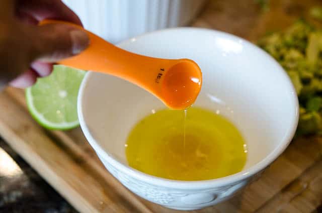 The dressing ingredients are combined in a small white bowl.