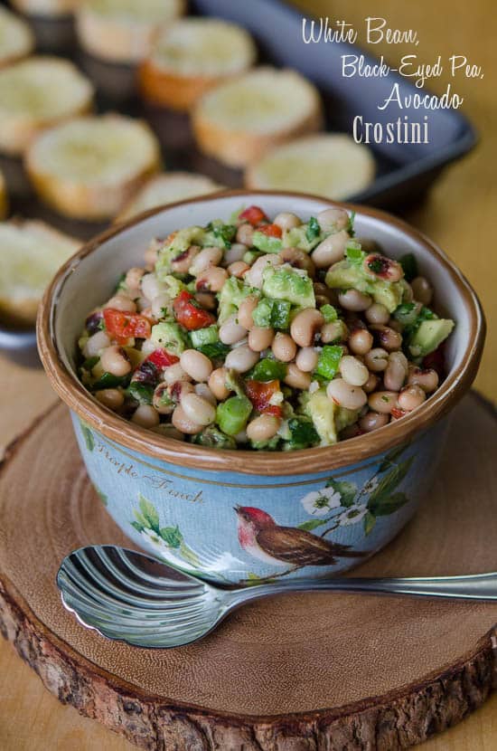 White beans, black eyed peas and avocados mixture in a small serving bowl.