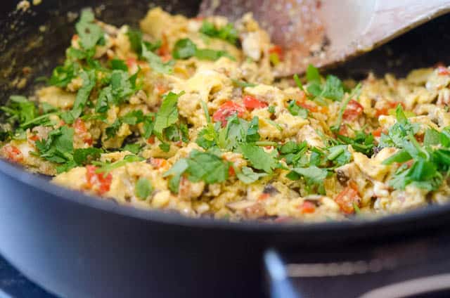 The cooked egg mixture is topped with cilantro.