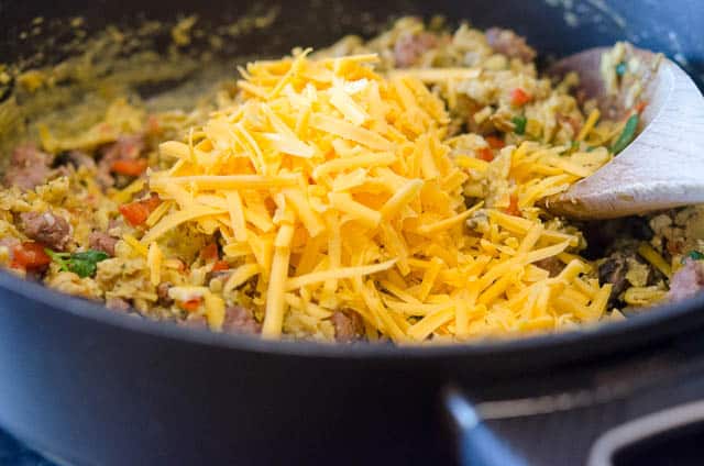 Shredded cheese is added to the egg mixture.