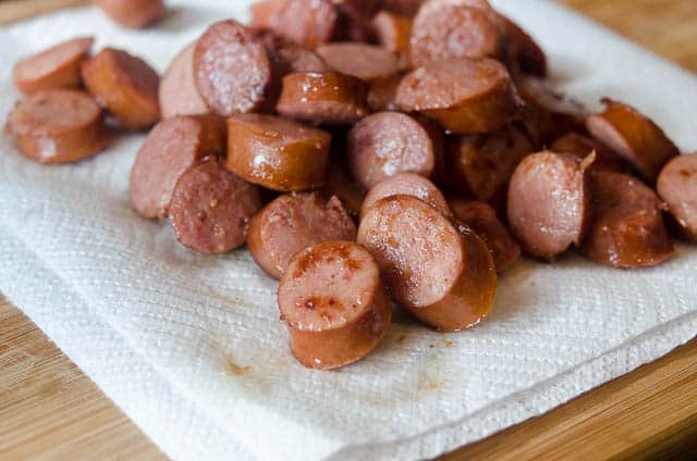 Browned sausage draining on paper towels.