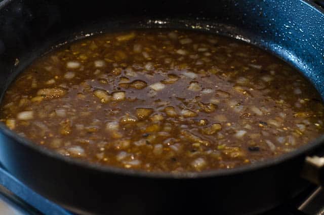 Simmering the braising sauce in the skillet.