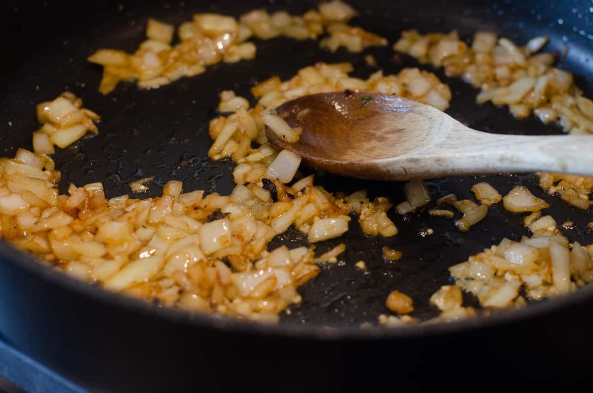 Onions cooking in a skillet.