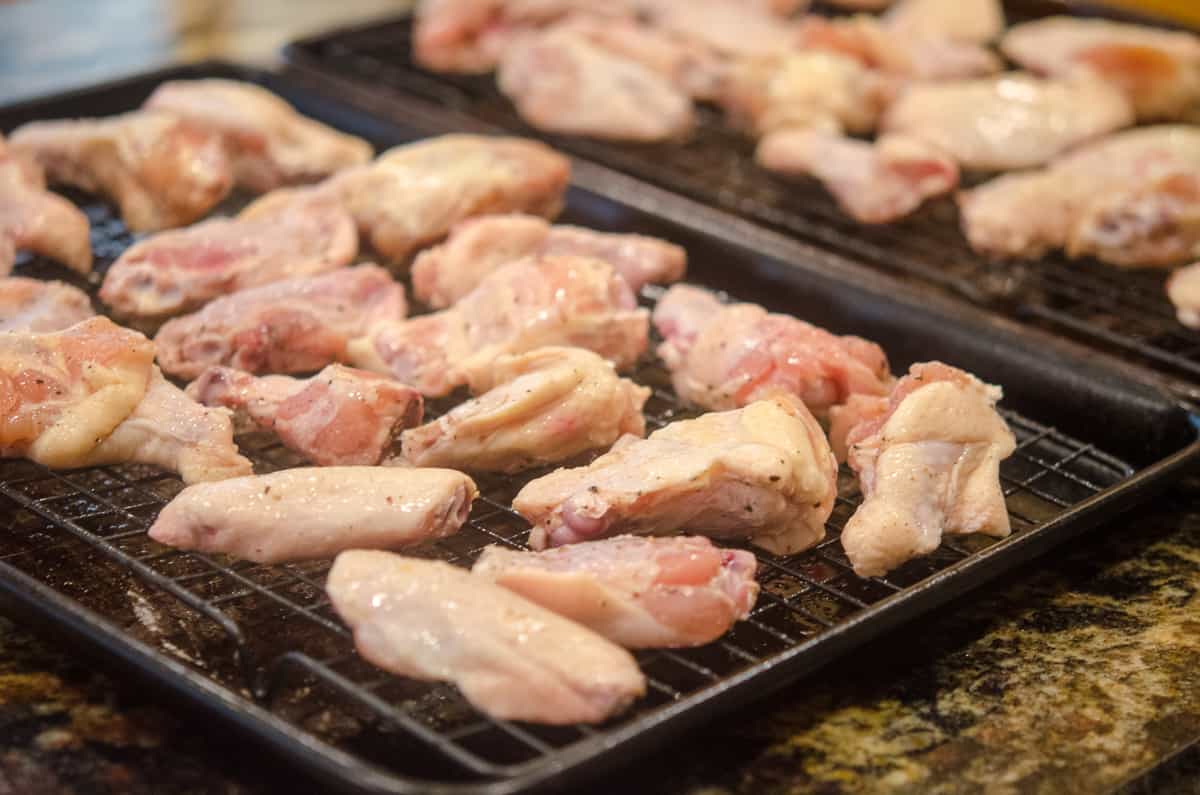 Chicken wings and drumettes on a wire rack.