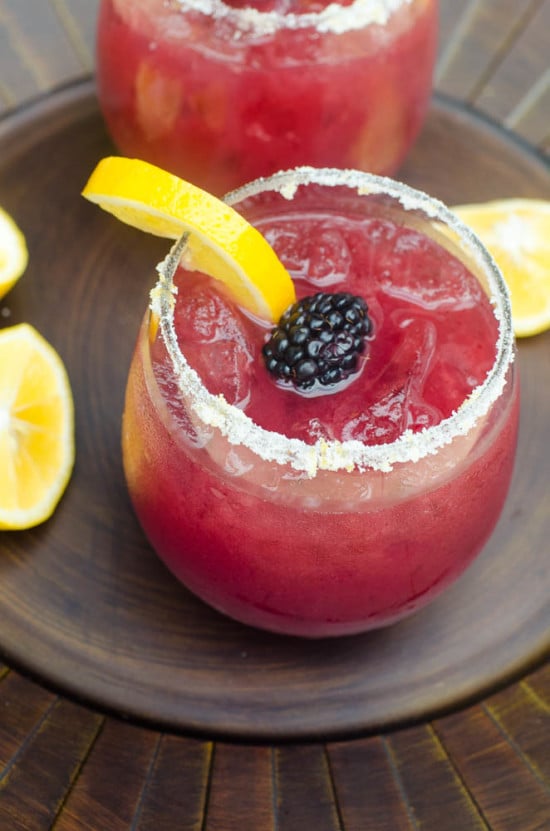 These festive, refreshing Blackberry Lemonade Margaritas include fresh blackberry puree, lemonade, and tequila. Tart, lightly sweet, and delicious. A great warm weather party drink!