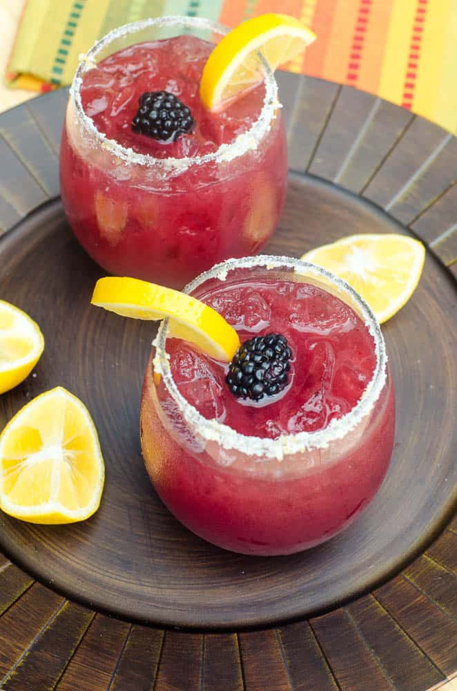These festive, refreshing Blackberry Lemonade Margaritas include fresh blackberry puree, lemonade, and tequila. Tart, lightly sweet, and delicious. A great warm weather party drink!