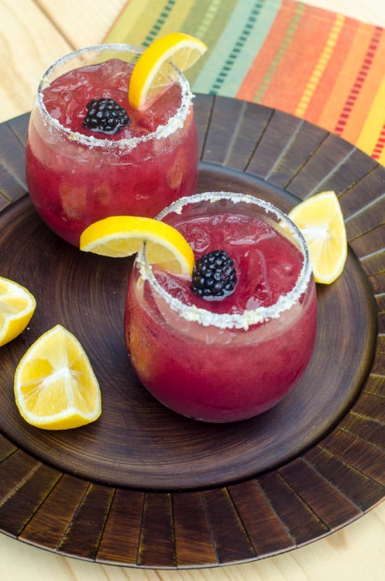 These festive, refreshing Blackberry Lemonade Margaritas include fresh blackberry puree, lemonade, and tequila. Tart, lightly sweet, and delicious. A great warm weather party drink!