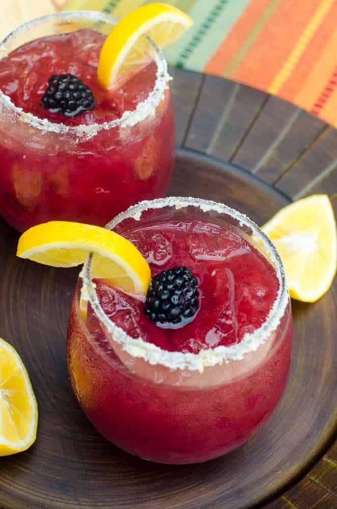 These festive, refreshing Blackberry Lemonade Margaritas include fresh blackberry puree, lemonade, and tequila. Tart, lightly sweet, and delicious. A great warm weather party drink!