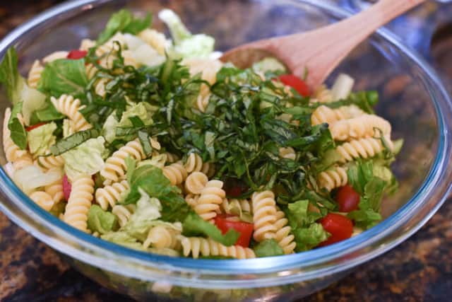 Mixing the ingredients together in a glass mixing bowl.