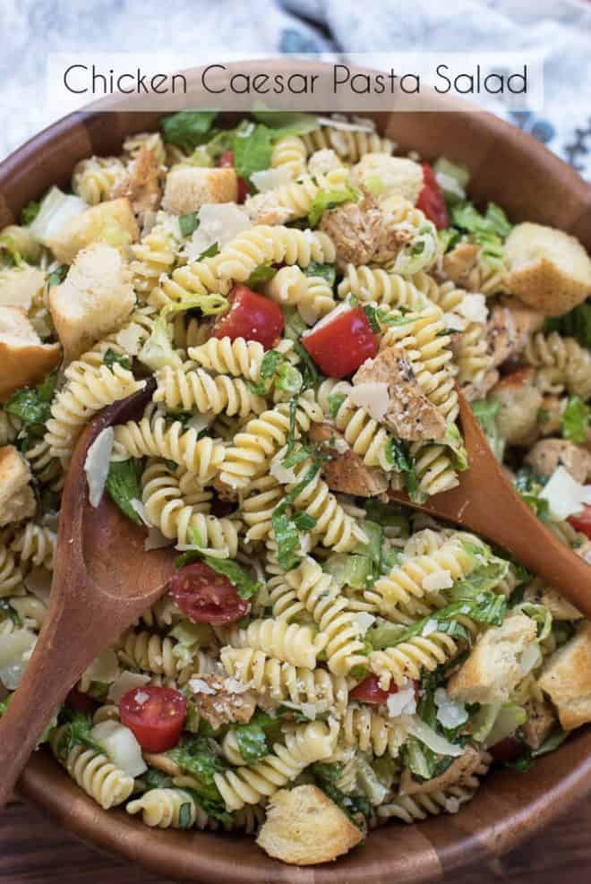 Chicken Caesar Pasta Salad in a wooden serving bowl with overlay text.