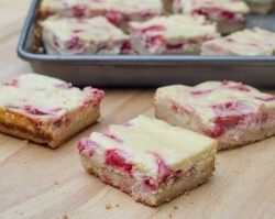 Strawberry Cheesecake Cookie Bars on a cutting board.