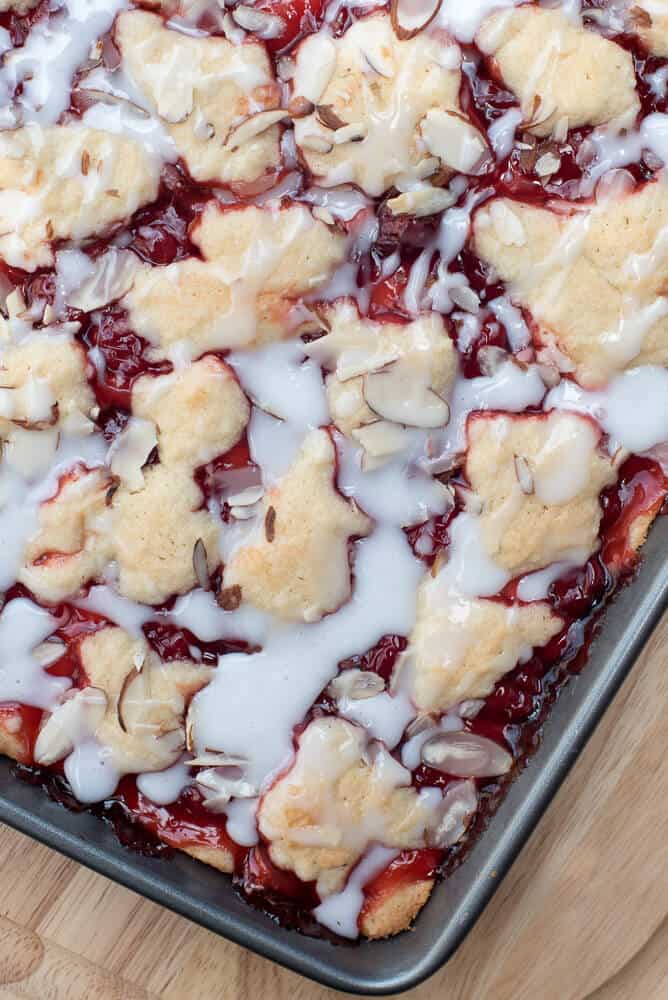 A close up image of Cherry Pie Bars on a rimmed baking sheet.
