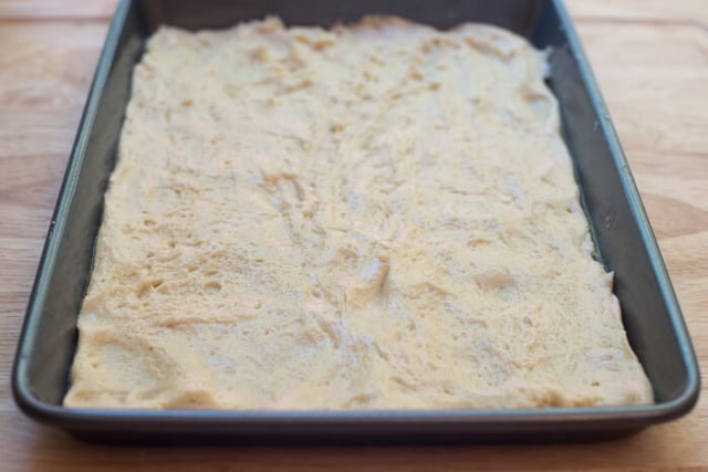 The dough spread out into a rimmed baking sheet.