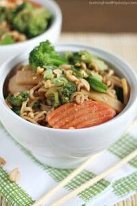 A white bowl filled with noodles and vegetables.