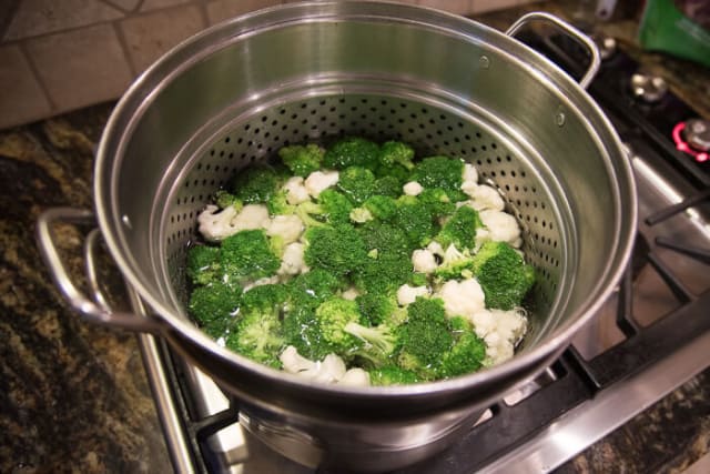 Broccoli and cauliflower florets in a pasta pot.