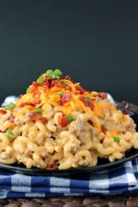 Macaroni and cheese with ground beef piled on a plate.