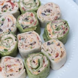 Green and white pinwheels on a white plate.