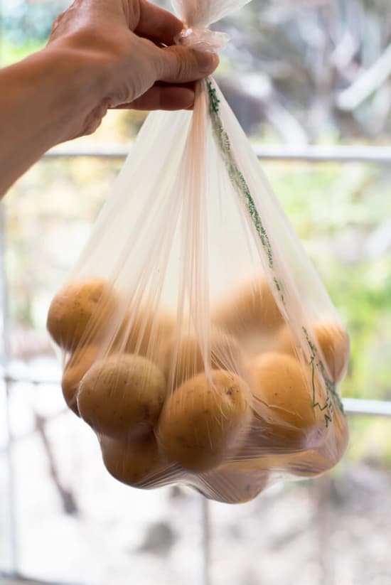 A plastic bag filled with baby gold potatoes.