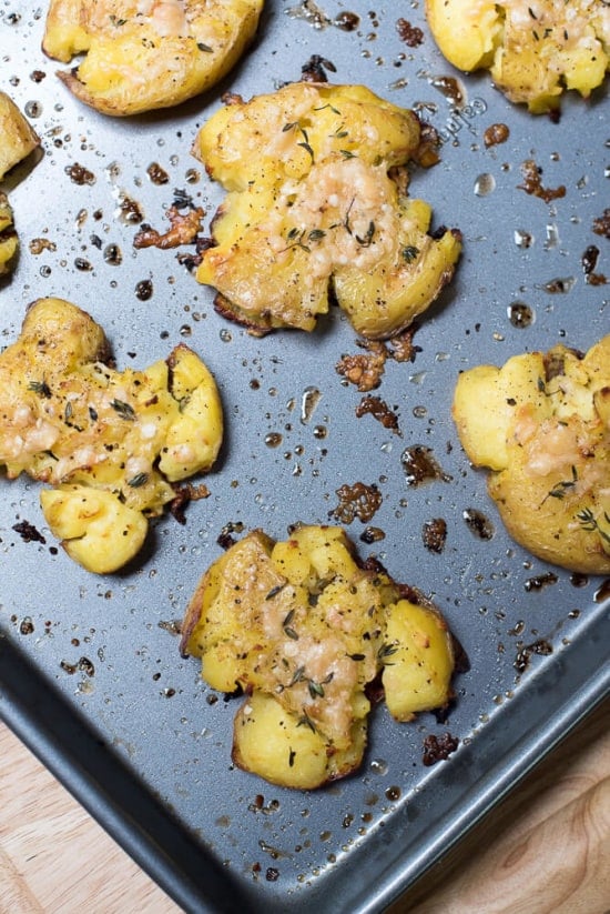 Crispy Parmesan Smashed Potatoes on a baking sheet.